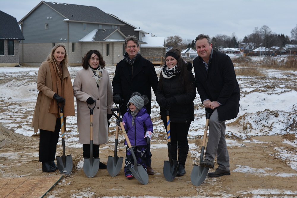 ground-breaking ceremony with people holding shovels to the ground at habitat event in Tillsonburg