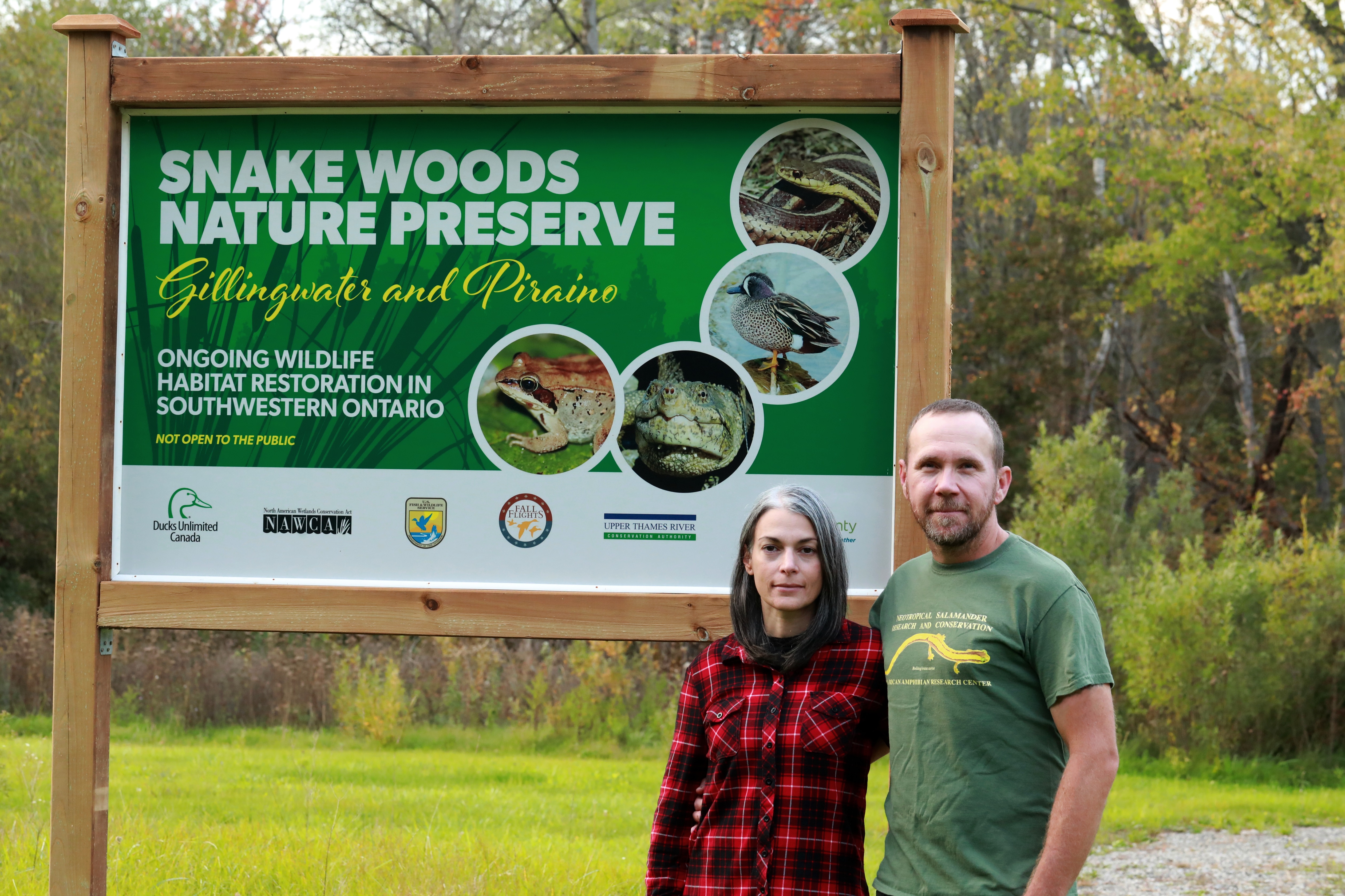 Award winners next to snake woods nature preserve billboard