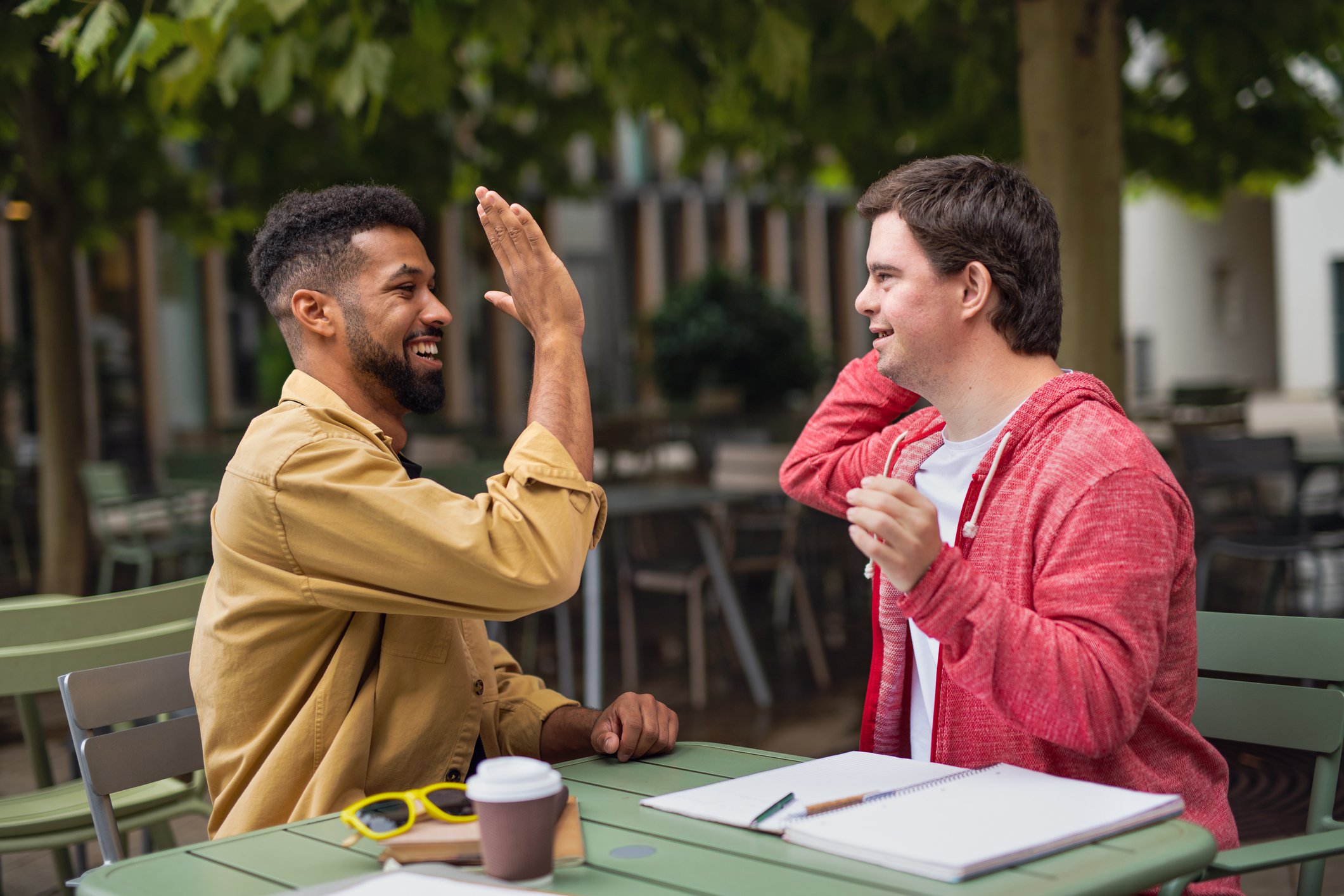 Man mentoring a student giving each other a high five