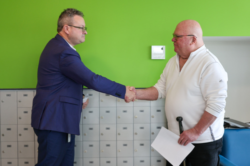 Warden Marcus Ryan shaking hands with the WNPH board director