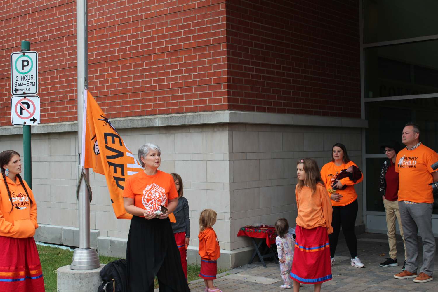 Members of ISAN speaking ahead of the Every Child Matters flag raising